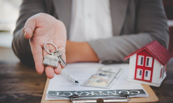 salesperson holding house keys concept